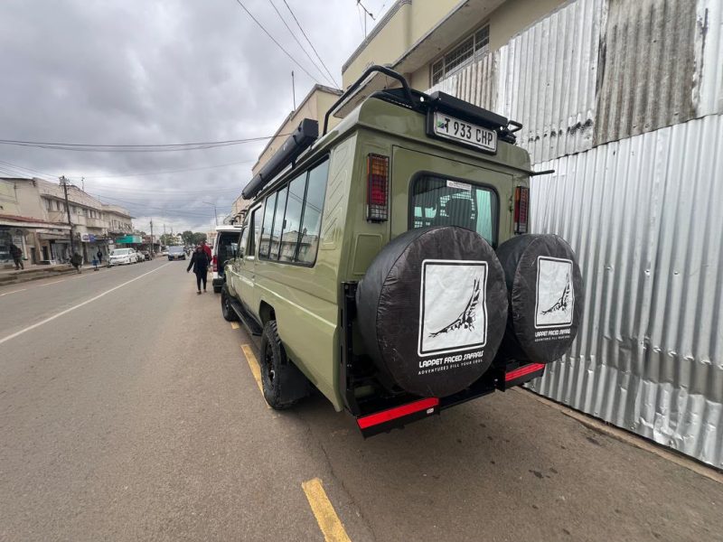 Lappet Faced Safaris vehicle parked on a street in town