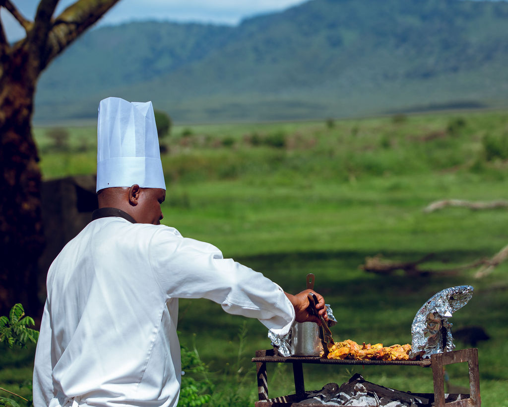 Chef preparing a meal at a field kitchen on the open plains