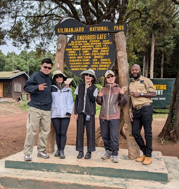 Trekking group at the Kilimanjaro National Park sign at Londorossi Gate