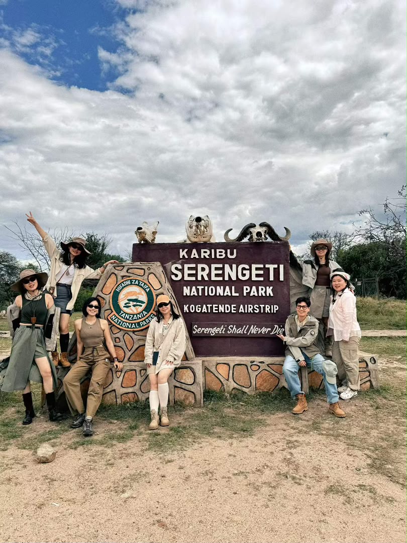 Safari guests at the Karibu Serengeti National Park sign at Kogatende airstrip