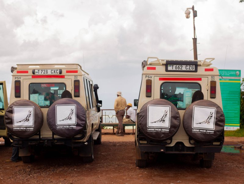 Two Lappet Faced Safaris vehicles parked at a viewpoint